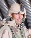 Head and shoulders of smiling man in circa 2000 U.S. Army battle dress.