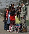A U.S. Soldier, assigned to the United Nations Command Security Battalion, meets local children while visiting Tae Sung Dong Elementary School, at Daeseong-dong.