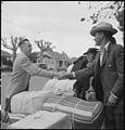 Friends say good-bye as a Japanese American family waits for a bus to an internment camp