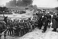 Hitler watches as the Army, followed by the Einsatzgruppen, march into Poland