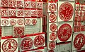 Red paper cuttings, most with the Chinese words for "Spring" or "Luck"