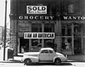 A Japanese American grocer put up these signs just before his internment