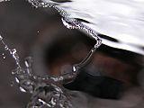 Breakup of a moving sheet of water bouncing off of a spoon.