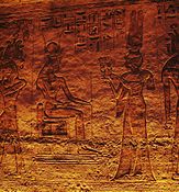 Nefertari offering sistrums to seated goddess Hathor