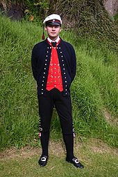 Faroese are increasingly wearing their traditional costumes again; nowadays almost every high school graduate wears them at the graduation ceremony (here with the typical student cap).