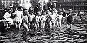 Boys and girls in a fountain in Trafalgar Square, c. 1912