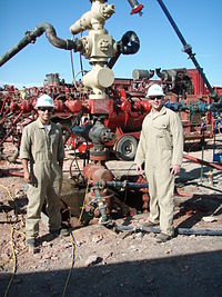 Fracking well site in operating condition with feed lines