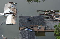 Menschen auf den Dächern ihrer Häuser, um das Hochwasser zu vermeiden