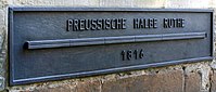 Et skilt på rådhuset i Münster, Tyskland, der angiver, at den viste bar er en "preussisk halv stang" lang