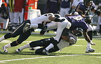 Quarterback Steve McNair terlihat ditekel selama pertandingan Oktober 2006 melawan San Diego Chargers.