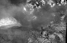 June 21: A German machine gunner, his field of vision limited by smoke, guards a roadblock during a training mission.