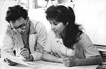 Engineer and technical draughtswoman with construction plans (1960)