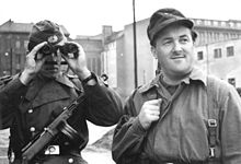 A Volkspolizist and a Kampfgruppen member secure the construction of the Wall, August 1961