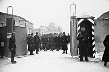 Propaganda photograph: A group of about 50 prisoners awaiting release at the camp gate (December 1933).