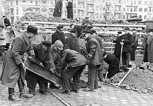 Volkssturm men dig steel girders to reinforce an anti-tank barrier at Hermannstrasse S-Bahn station in Neukölln on March 10, 1945