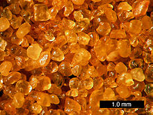Quartz sand from Coral Pink Sand Dunes State Park, Utah; the orange coloration is due to hematite overlay.