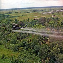 Defoliant spraying in the Mekong Delta in July 1969 by a Bell UH-1 helicopter.
