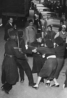 Policemen arrest pro-Soviet activists outside a British bank