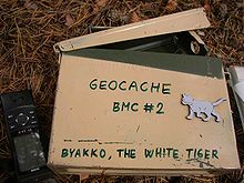Regular geocache with GPS receiver (left)