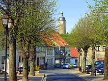 Place des Tilleuls. In the background, the Tour de l'Horloge on the medieval motte.