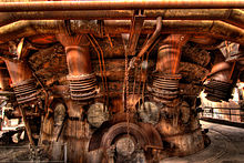 Tapping area with hot blast ring pipe and largely dismantled blast nozzles of the disused blast furnace at the Völklingen Ironworks