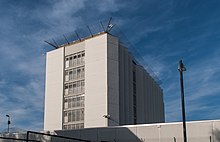 A wall surrounds the prison building to prevent escapes.