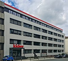 Headquarters of the Kicker editorial office in Nuremberg with the Kicker statue in front of the main entrance