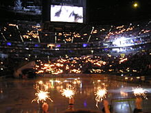 Darkened LANXESS Arena illuminated by Cologne Haie fans
