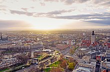 View from the City-Hochhaus in south-west direction: on the right New City Hall, on the left Propsteikirche St. Trinitatis, in the background Federal Administrative Court and Leipzig's Auwald forest (2015)