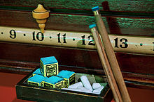 Billiard chalk (left) and cue (right) with ferrule (gold) and bitter lance (blue)