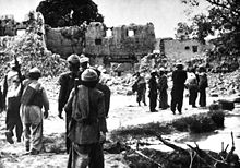 Armed Mujahideen in a destroyed village, 1988