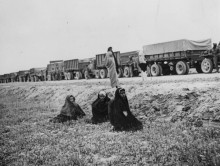 Women looking at an Allied supply convoy for the USSR on the "Persian Corridor", somewhere between Tehran and Bandar Pahlawi, June 1943 (today's name: Bandar Anzali).