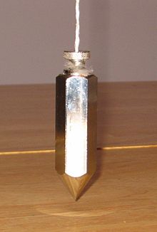 A plumb line shows the direction of the gravitational field