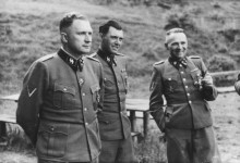 Josef Mengele (center) between commanders Richard Baer (left) and Rudolf Höß at the Solahütte near Auschwitz, 1944. Photograph from Karl-Friedrich Höcker's Auschwitz album.