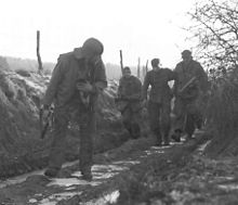 U.S. patrol with a captured SS soldier, December 25, 1944.