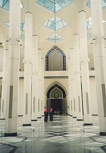 Two women and a man at the Selangor Mosque in Shah Alam, Malaysia