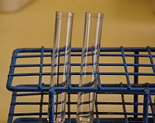Test tubes in a stand made of coated wire.