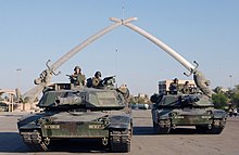 M1A1 Abrams main battle tank in front of the triumphal arch Hands of Victory