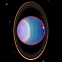 Uma imagem quase infravermelha falsa de Urano de 1998 mostrando faixas de nuvens, anéis e luas obtidas pela câmera NICMOS do Telescópio Espacial Hubble