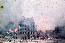 Warsaw Uprising, August - October 1944: burning house in the Old Town (Agfacolor photo). Photographer: Ewa Faryaszewska (1920-1944)