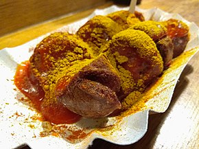 Currywurst in cardboard bowl