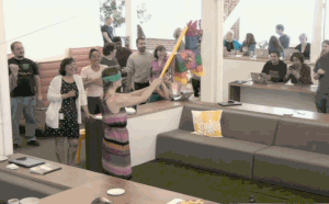 A woman smashes a piñata