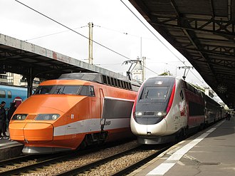 Power car in original colors (TGV Sud-Est) of the pre-production train 01 and TGV Duplex in the color scheme Lyria in the Paris terminus station Gare de Lyon (2020)