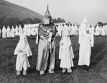 The Ku Klux Klan were allowed to attack Freedom Riders in Montgomery. Here two children stand with a KKK leader