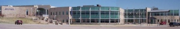Exterior view of Columbine High School showing the stairs to the west entrance and the window front of the cafeteria on the ground floor and the (former) library on the floor above.