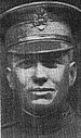 Head of man in his late twenties, wearing a U.S. Army officer's peaked cap