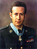 A color image showing Penry from the waist up in his military dress uniform with ribbons. His Medal of Honor is visible around his neck.