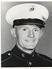 A black and white head shot of Singleton wearing his military dress uniform with hat.