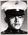 A head and shoulders portrait of a young, cleanshaven man, wearing a formal military uniform and a hat.