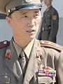A Korean People's Army Lieutenant Colonel in the JSA. His decorations include a Kim Il Sung lapel badge, Order of the National Flag 2nd class (awarded for at least 20 years service in the Korean Workers' Party) and two Medals For Military Service.